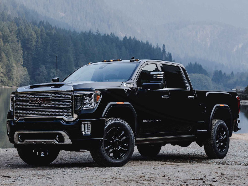 GMC Truck in front of pine trees